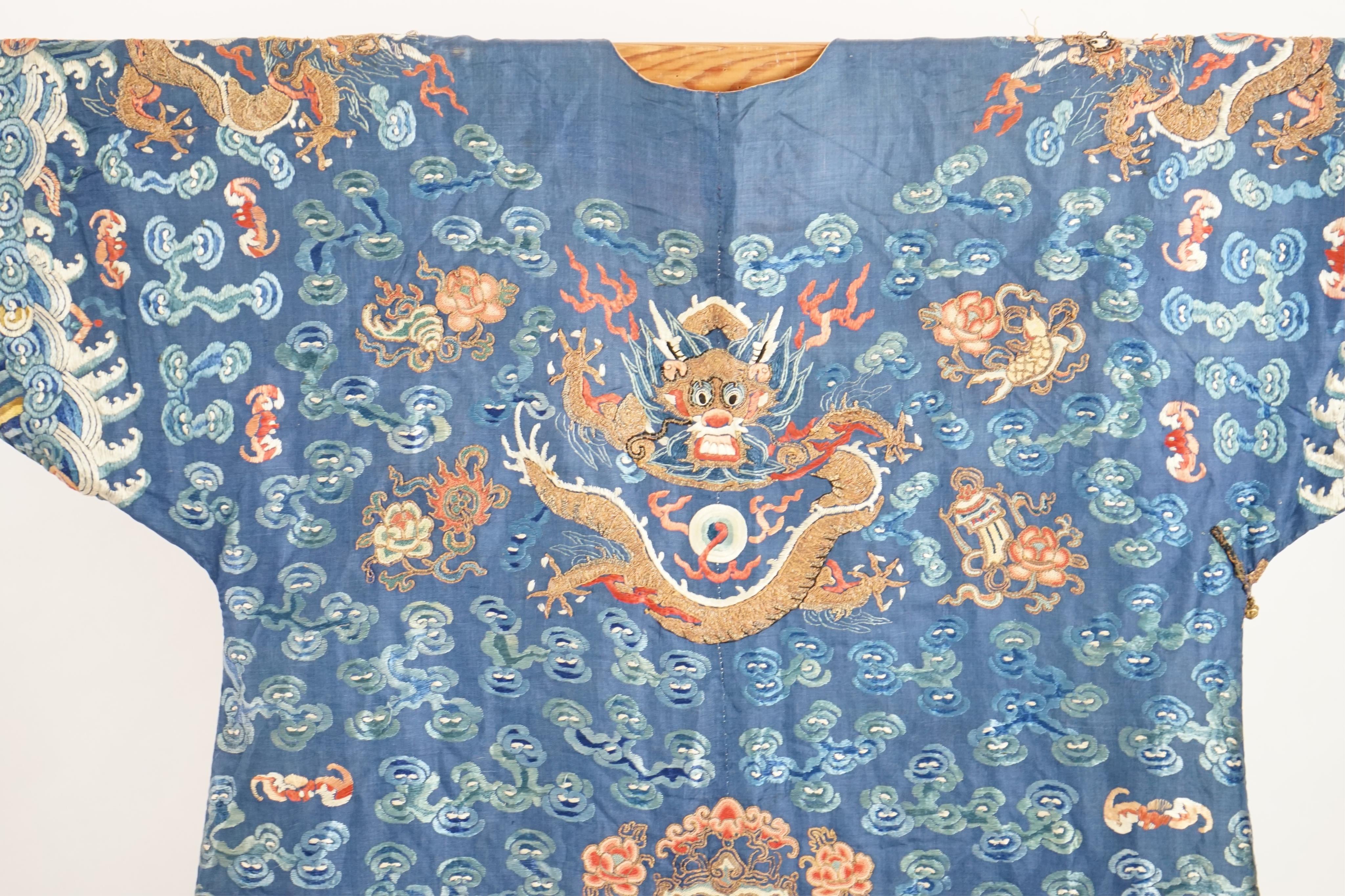 A Chinese blue silk ‘dragon’ robe, jifu, late 19th century and a mandarin hat